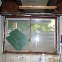 Old, rusty, steel basement windows.